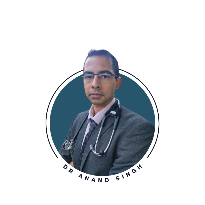 Portrait of Dr Anand Singh wearing glasses and a stethoscope, in a grey suit.